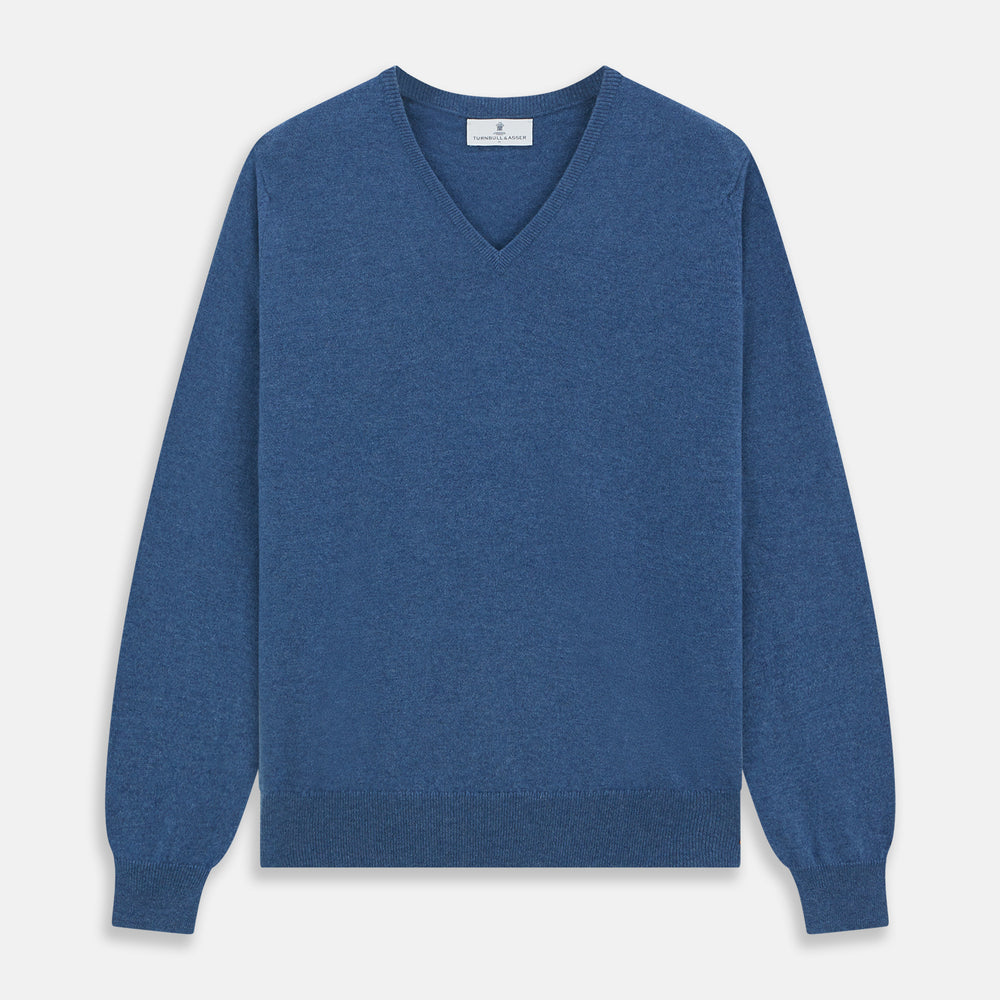 The Turnbull & Asser Blue V-Neck Cashmere Jumper, crafted from soft Scottish cashmere with ribbed cuffs, hem, and neckline, is shown laid flat on a white background for a refined smart-casual appeal.