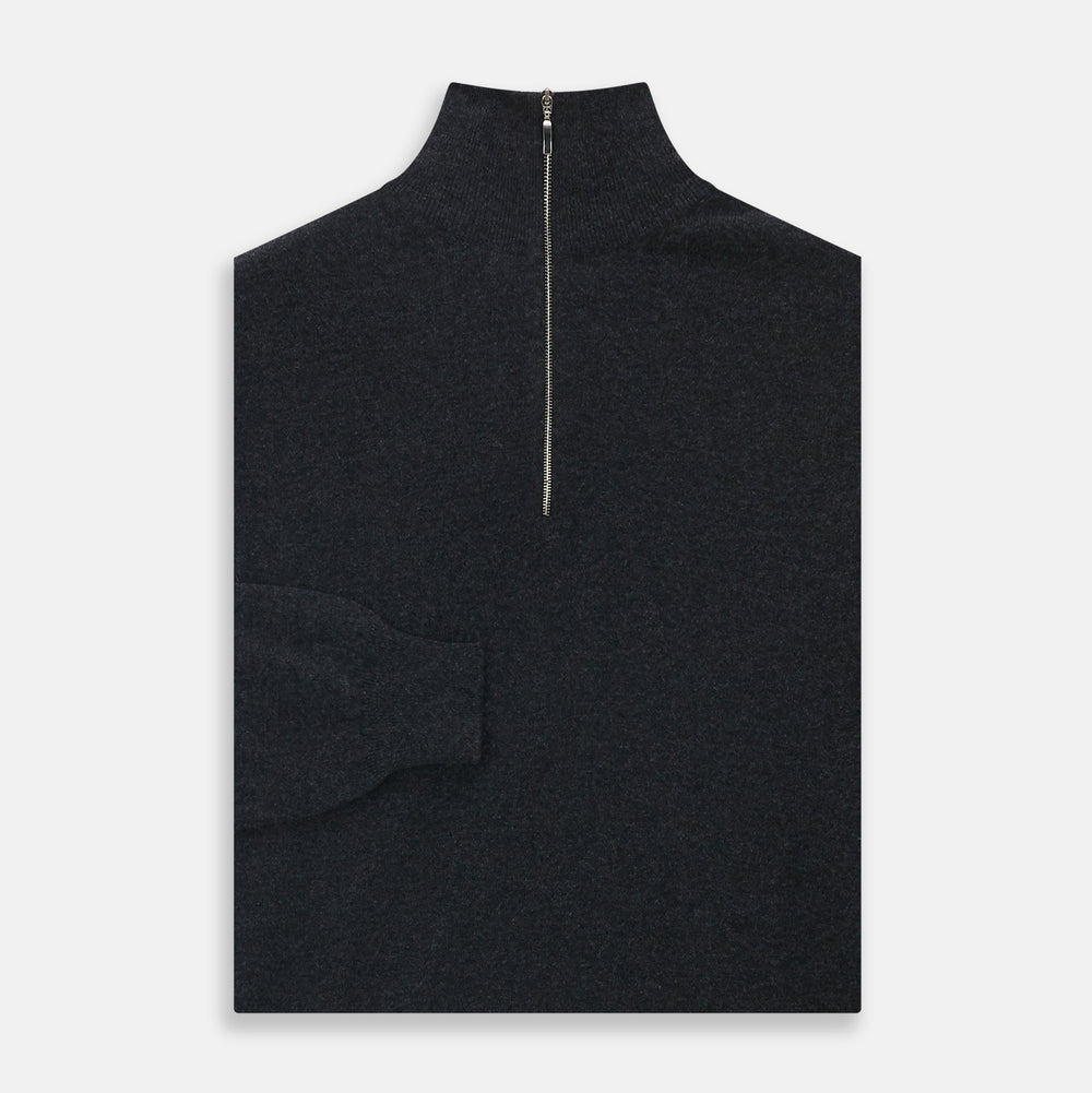 The Turnbull & Asser Charcoal Half-Zip Cashmere Jumper features long sleeves, a high collar, and a zip closure from the collar down the chest. Displayed flat with sleeves extended, it is crafted in dark charcoal grey cashmere.