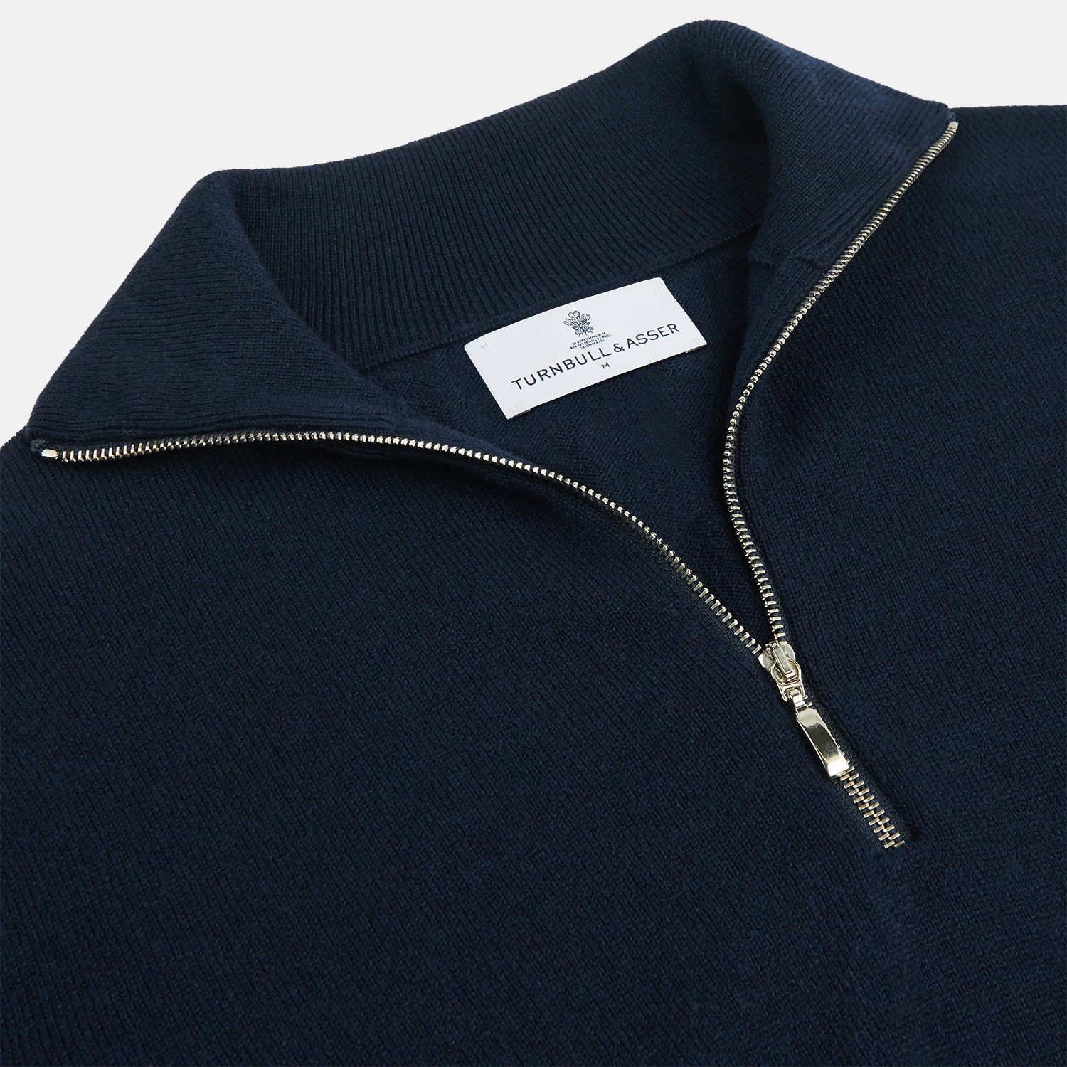 View 2 of product The Turnbull & Asser Navy Half-Zip Cashmere Jumper features a high collar and silver quarter-zip closure, shown flat on a white background.