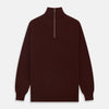 View 1 of product The Turnbull & Asser Port Cashmere Half-Zip Jumper is a dark maroon, long-sleeve style with a high collar, silver half-zip, and ribbed cuffs and hem, shown laid flat on a white background—ideal for layering.