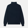 View 4 of product The Turnbull & Asser Navy Cashmere Roll Neck Jumper, with ribbed cuffs and hem, is a timeless autumn essential. Shown laid flat on a white background, this plain long-sleeved sweater offers classic style and comfort.