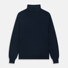 View 1 of product The Turnbull & Asser Navy Cashmere Roll Neck Jumper, with ribbed cuffs and hem, is a timeless autumn essential. Shown laid flat on a white background, this plain long-sleeved sweater offers classic style and comfort.