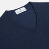 View 2 of product The Blue V-Neck Merino Wool Jumper by Turnbull & Asser features long sleeves, ribbed cuffs, and a ribbed hem—a timeless essential for any gentleman's wardrobe, shown laid flat on a white background.