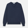 View 1 of product The Blue V-Neck Merino Wool Jumper by Turnbull & Asser features long sleeves, ribbed cuffs, and a ribbed hem—a timeless essential for any gentleman's wardrobe, shown laid flat on a white background.