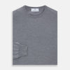 View 3 of product The Turnbull & Asser Grey Crew Neck Merino Wool Jumper, a timeless long-sleeved staple, is shown laid flat on a white background.