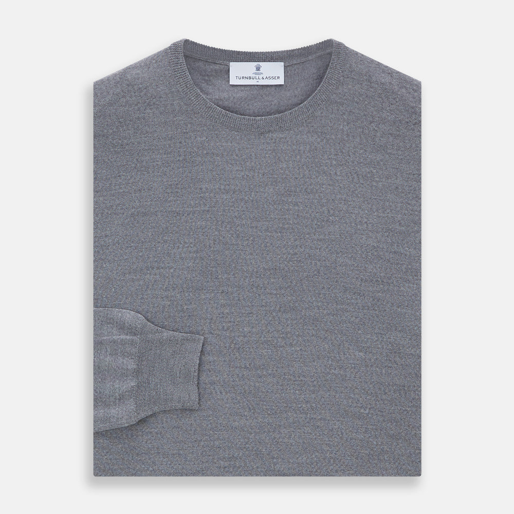 The Turnbull & Asser Grey Crew Neck Merino Wool Jumper, a timeless long-sleeved staple, is shown laid flat on a white background.