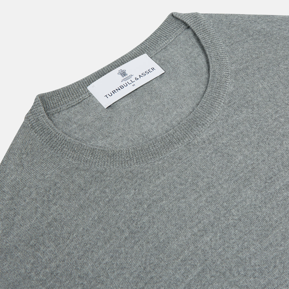 The Turnbull & Asser Grey Crew Neck Merino Wool Jumper, a timeless long-sleeved staple, is shown laid flat on a white background.