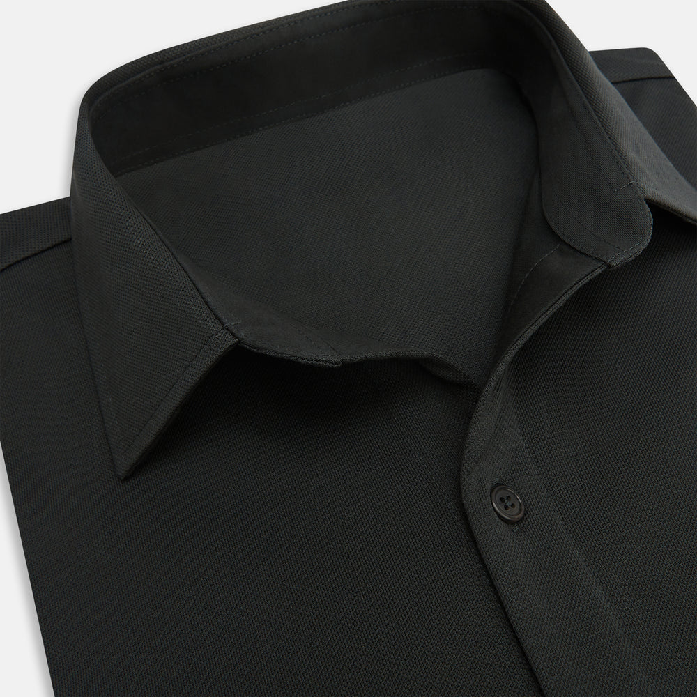 The Moss Green Pique Shirt by Turnbull & Asser, featuring long sleeves, a button-up front, collar, and single chest pocket, is laid flat on a white background for a refined take on classic style.