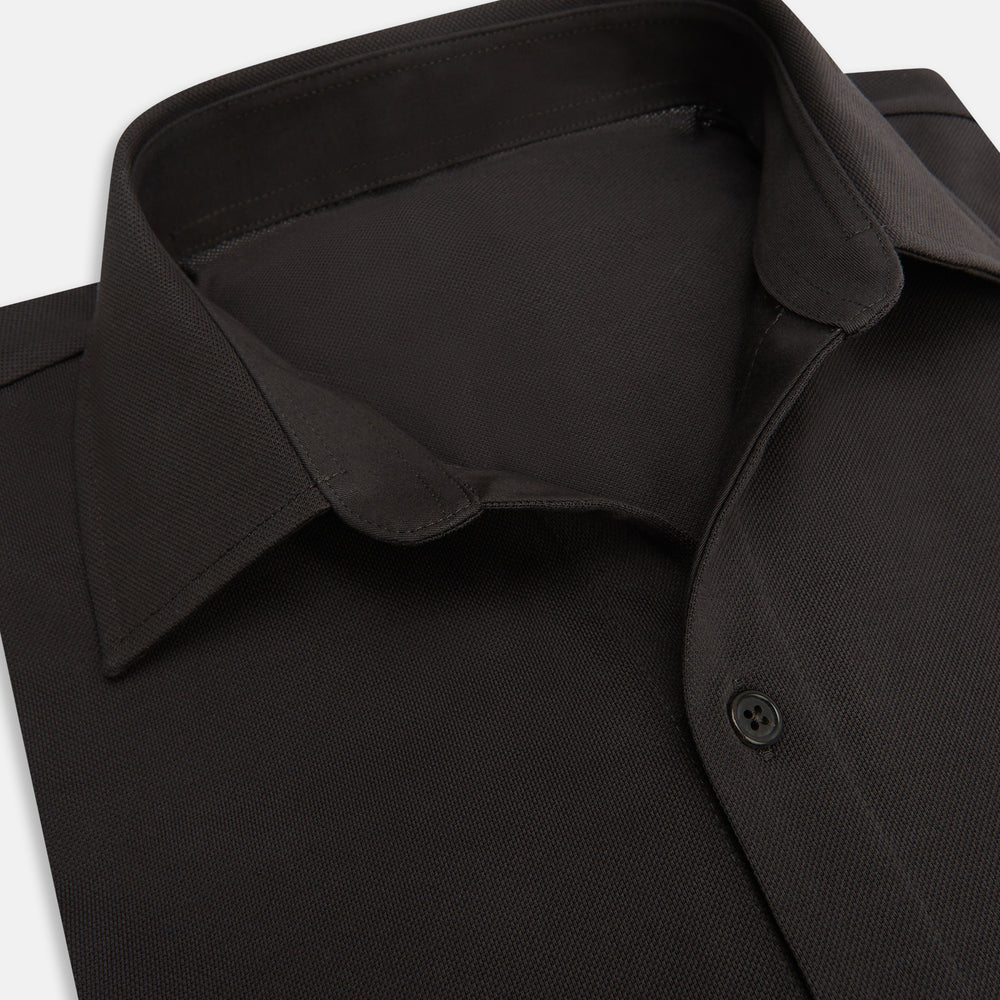 A Brown Pique Shirt by Turnbull & Asser, featuring long sleeves, a collar, and a single chest pocket, is laid flat on a white background.