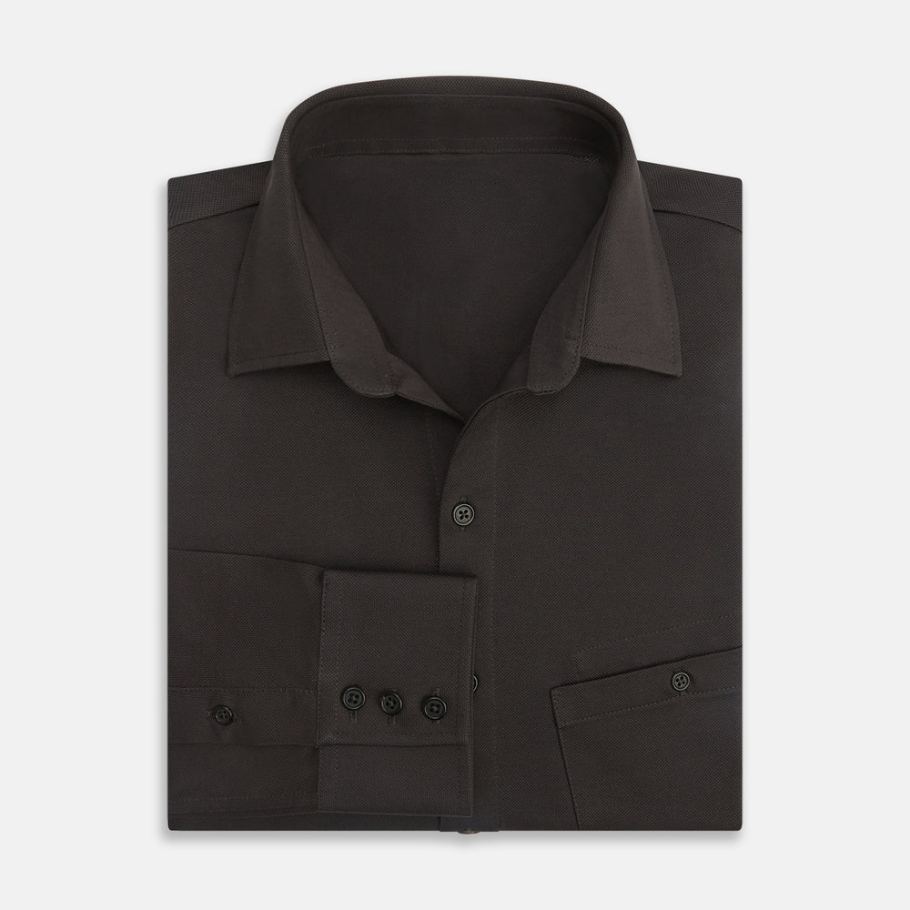 A Brown Pique Shirt by Turnbull & Asser, featuring long sleeves, a collar, and a single chest pocket, is laid flat on a white background.