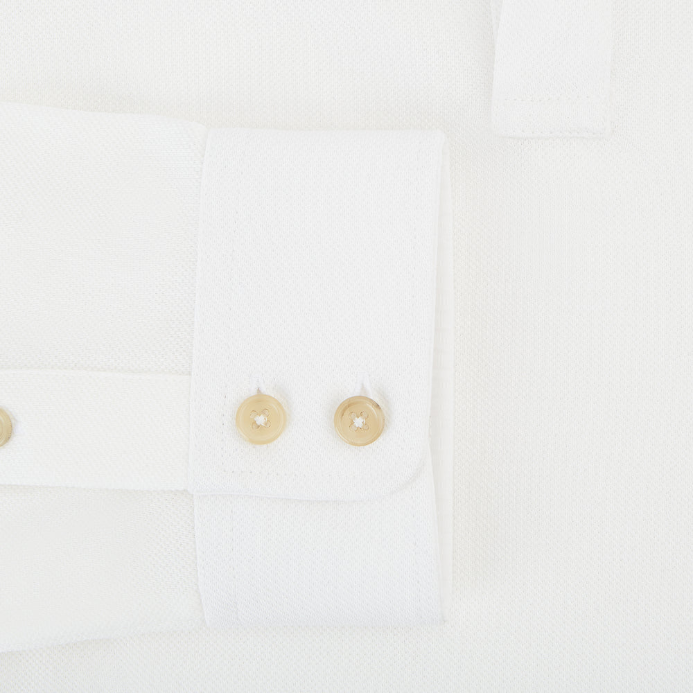 A Cream Rugby Polo Shirt in Cotton by Turnbull & Asser UK, featuring long sleeves, a collar, and a partial button placket, is displayed on a white background.