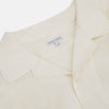 View 2 of product The Cream Nightshirt by Turnbull & Asser is a long-sleeved, cream-colored shirt dress with a collar, partial button front, chest pocket, and relaxed fit—ideal as comfortable sleepwear—shown on a plain white background.