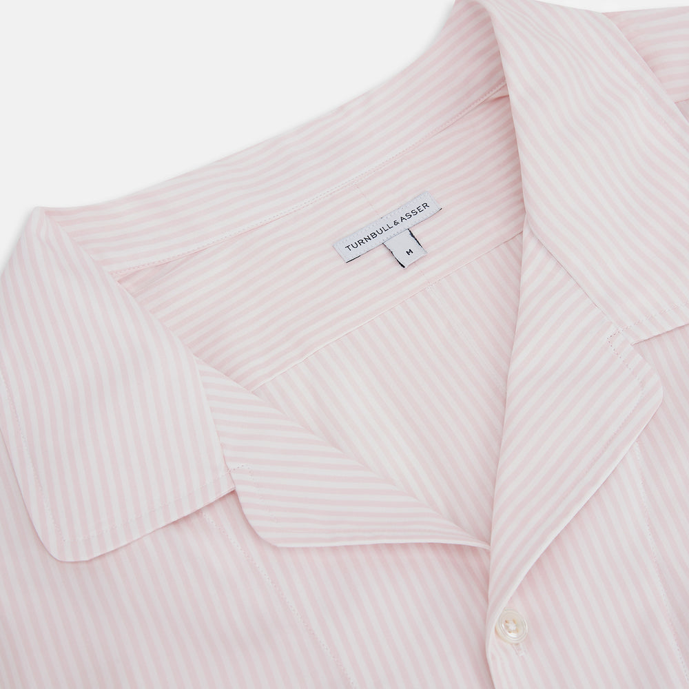 The Turnbull & Asser Pale Pink Bengal Stripe Nightshirt features long sleeves, a subtle striped pattern, a collar, chest pocket, and front buttons. Shown flat on a white background, this stylish sleepwear offers comfort and elegance.