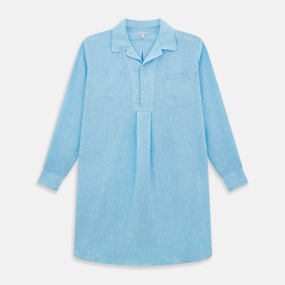The QUARZO NIGHTSHIRT TURQUOISE LINEN by Turnbull & Asser is a relaxed-fit, long-sleeve collared nightshirt in soft turquoise linen, featuring a chest pocket and button placket, shown laid flat on a white background.
