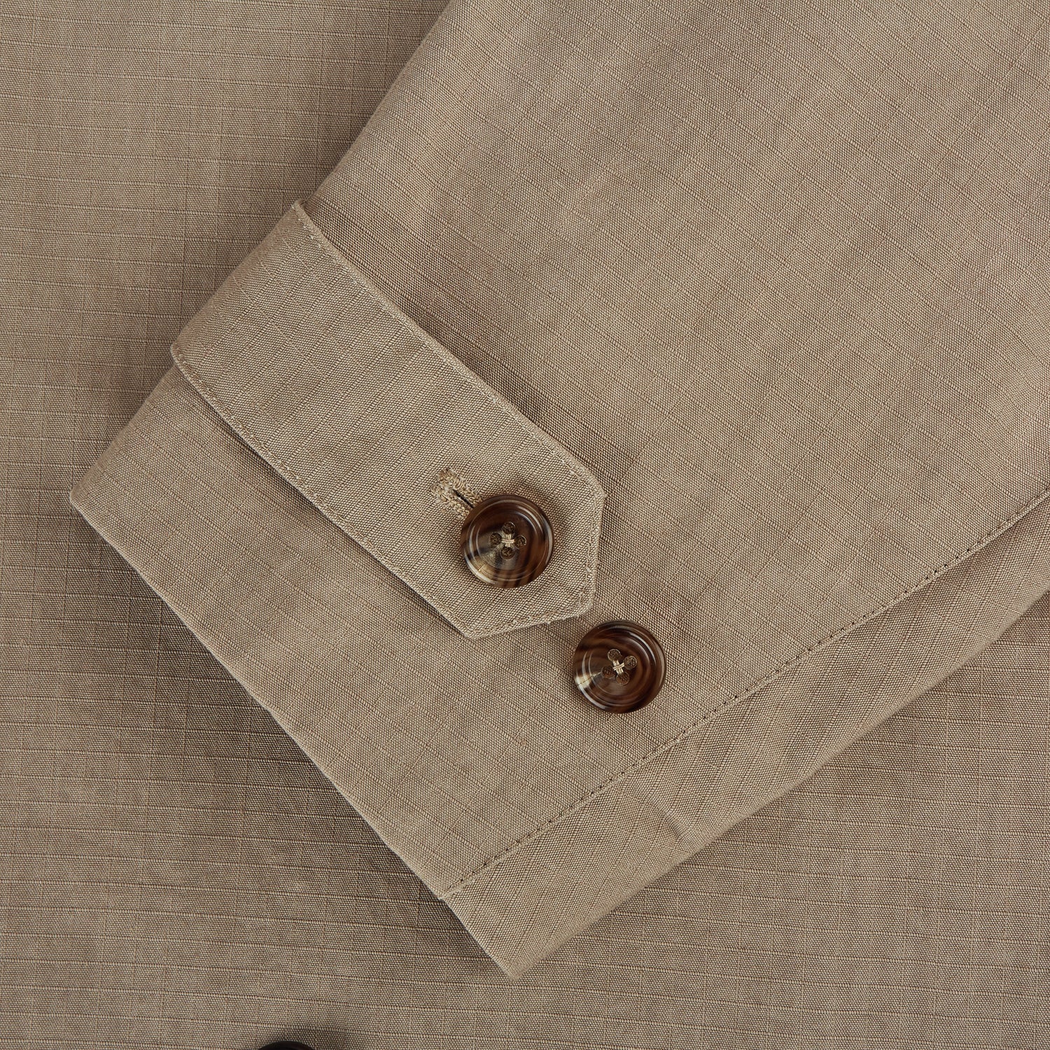 View 4 of product The Sand Long Albert Trench Coat by Turnbull & Asser UK features a double-breasted design, dark buttons, notched collar, and two slanted front pockets, offering timeless British style. Shown against a plain white background.