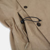 View 5 of product The Sand Long Albert Trench Coat by Turnbull & Asser UK features a double-breasted design, dark buttons, notched collar, and two slanted front pockets, offering timeless British style. Shown against a plain white background.