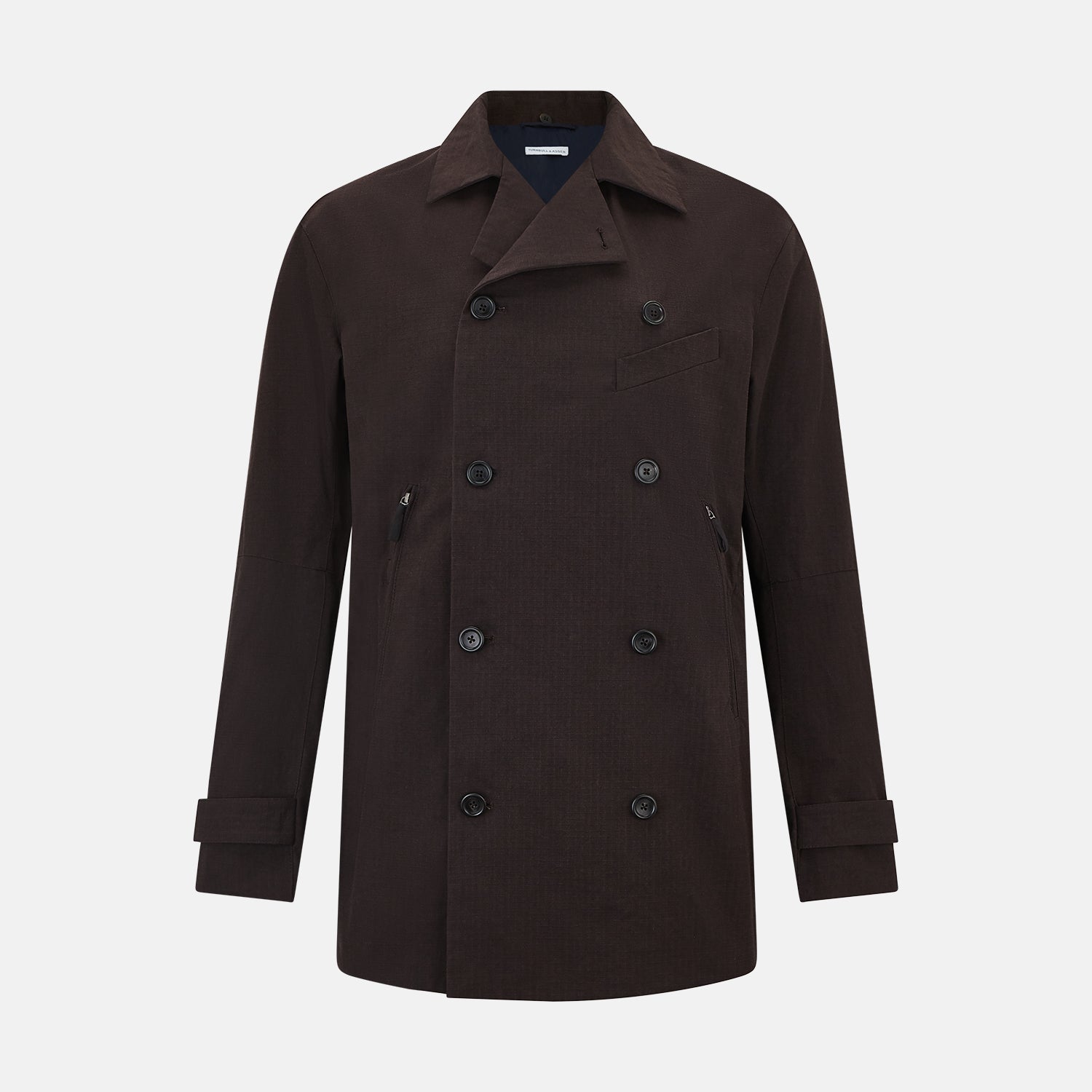 View 1 of product The Turnbull & Asser UK Dark Chocolate Short Albert Trench Coat features a double-breasted style, black buttons, notched collar, chest pocket, two side zip pockets, and adjustable cuff straps—shown on a plain white background.