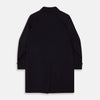 View 4 of product The Turnbull & Asser Dark Navy Cashmere Storm System Smith Coat, featuring a classic collar, buttoned front, side pockets, and buttoned cuffs, is shown laid flat on a white background.
