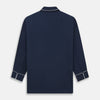 View 5 of product The Turnbull & Asser Navy Piped Cotton Pyjama Set features a navy blue long-sleeve top with white piping, front buttons, a chest pocket, and matching drawstring pants, all displayed on a white background.