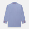 View 5 of product The Blue Piped End-on-End Cotton Pyjama Set by Turnbull & Asser features light blue long sleeves, red piping, front buttons, chest pocket, and matching drawstring pants—luxurious sleepwear laid flat on a white background.