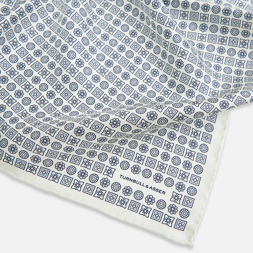 A white silk pocket square from Turnbull & Asser UK, featuring a floral pattern and discreetly finished with the brand’s logo in one corner, this Floral White Pocket Square is neatly folded to showcase both its design and craftsmanship.