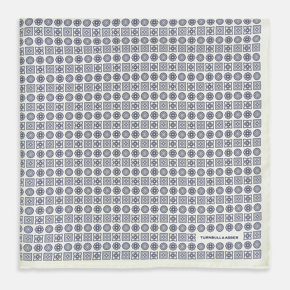 A white silk pocket square from Turnbull & Asser UK, featuring a floral pattern and discreetly finished with the brand’s logo in one corner, this Floral White Pocket Square is neatly folded to showcase both its design and craftsmanship.