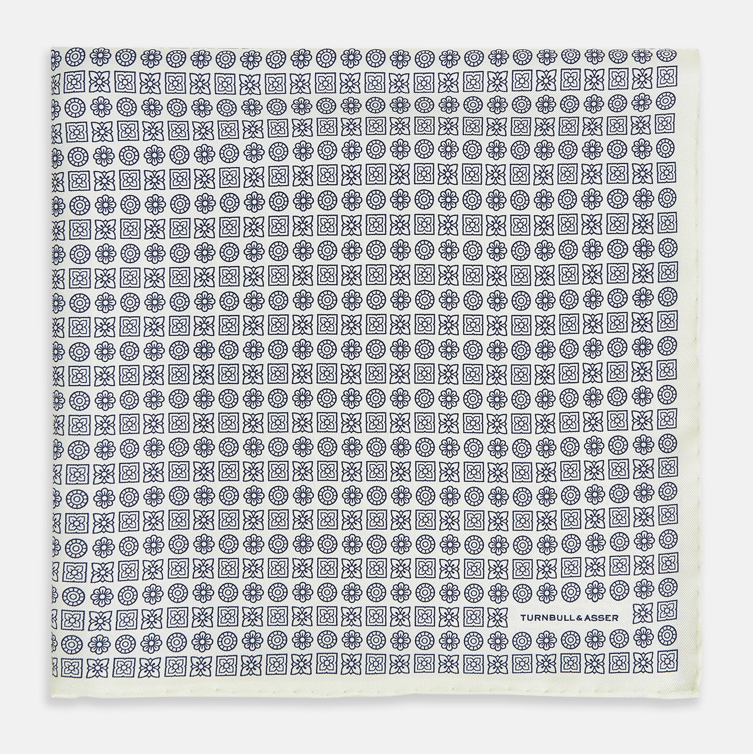 View 3 of product A white silk pocket square from Turnbull & Asser UK, featuring a floral pattern and discreetly finished with the brand’s logo in one corner, this Floral White Pocket Square is neatly folded to showcase both its design and craftsmanship.