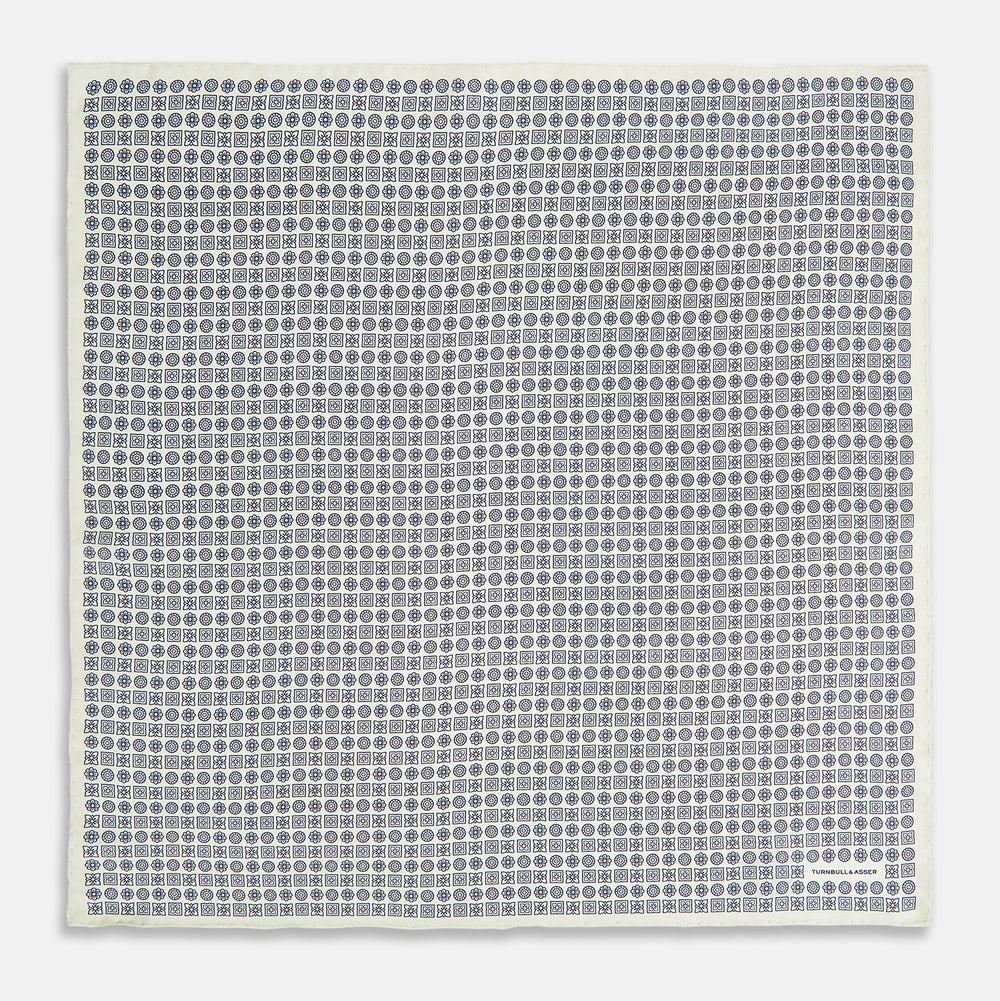 A white silk pocket square from Turnbull & Asser UK, featuring a floral pattern and discreetly finished with the brand’s logo in one corner, this Floral White Pocket Square is neatly folded to showcase both its design and craftsmanship.