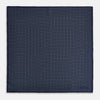 View 4 of product A Floral Navy Pocket Square in Silk by Turnbull & Asser UK, featuring a repeating geometric pattern with the brand’s name printed in white in the corner—perfect for adding a touch of sophistication to formal tailoring. The top right edge is folded over to reveal the reverse side.