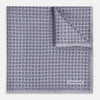 View 1 of product A lilac silk pocket square featuring a repeating geometric rosette pattern. One corner is folded over to show the reverse side, and "Turnbull & Asser UK" is printed in the bottom right corner.