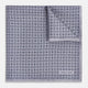 A lilac silk pocket square featuring a repeating geometric rosette pattern. One corner is folded over to show the reverse side, and "Turnbull & Asser UK" is printed in the bottom right corner.