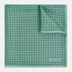 Floral Green Pocket Square in Silk by Turnbull & Asser UK, showcasing navy-blue floral geometric motifs on a bright green background. One corner is neatly folded to display both sides of the silk fabric, with "Turnbull & Asser UK" printed in the lower right corner.