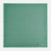 View 4 of product Floral Green Pocket Square in Silk by Turnbull & Asser UK, showcasing navy-blue floral geometric motifs on a bright green background. One corner is neatly folded to display both sides of the silk fabric, with "Turnbull & Asser UK" printed in the lower right corner.