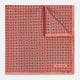 The Floral Orange Pocket Square in Silk by Turnbull & Asser UK features a coral and navy geometric floral pattern with orange accents, neatly folded at the corner. The brand name, Turnbull & Asser UK, is printed in white near the edge.