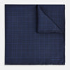 View 1 of product The Checked Blue On Navy Pocket Square in Silk by Turnbull & Asser UK is crafted from dark blue silk and features a subtle geometric design with a lighter blue grid pattern, finished with a discreet Turnbull & Asser logo in the corner.