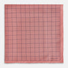View 3 of product Introducing the Checked Pink Pocket Square in Silk from Turnbull & Asser UK, crafted with a geometric grid pattern of black lines and micro dots on soft pink silk. The design features a neatly folded corner and "Turnbull & Asser" subtly printed in the bottom right.