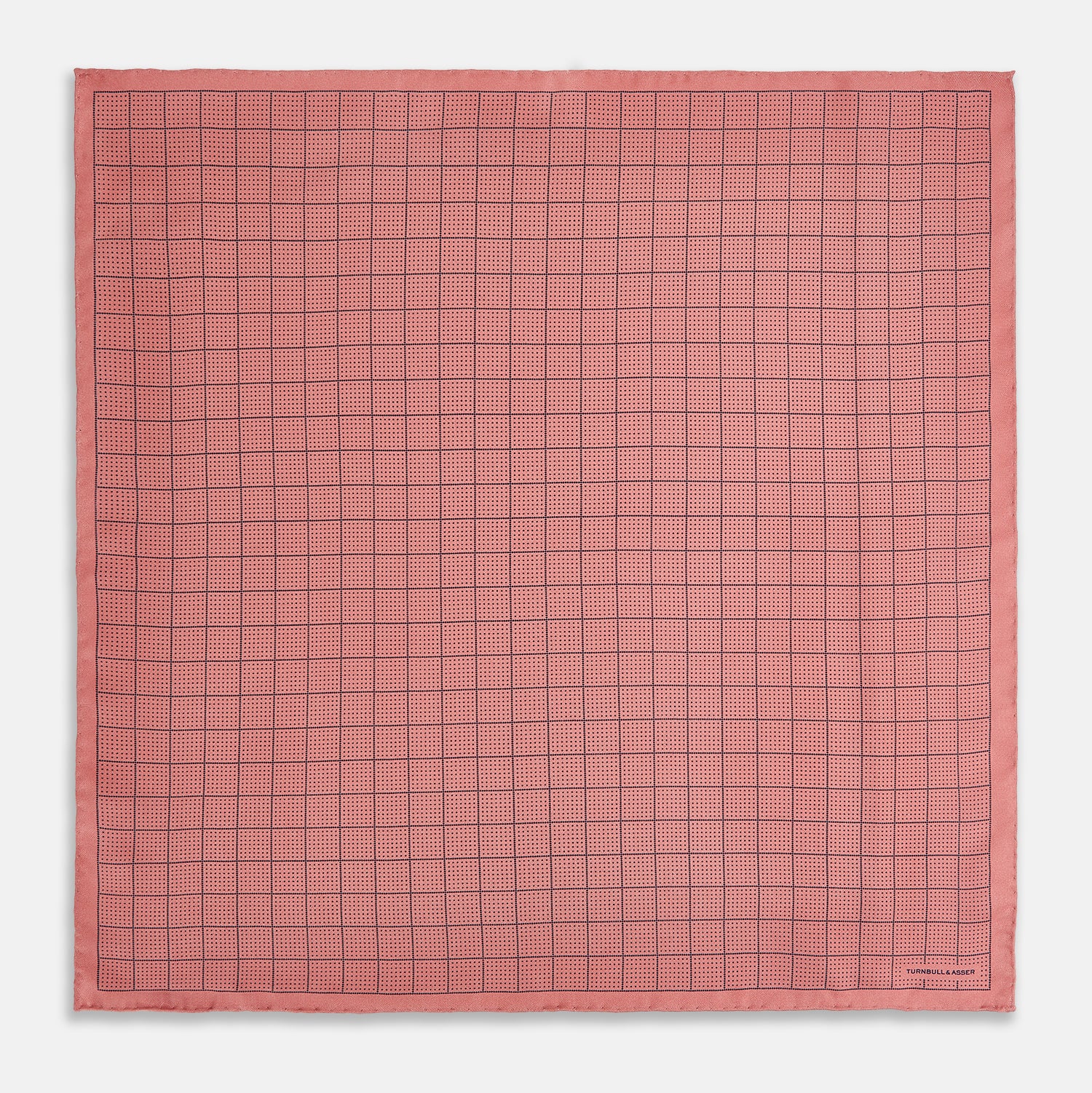 View 4 of product Introducing the Checked Pink Pocket Square in Silk from Turnbull & Asser UK, crafted with a geometric grid pattern of black lines and micro dots on soft pink silk. The design features a neatly folded corner and "Turnbull & Asser" subtly printed in the bottom right.