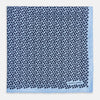 View 3 of product A light blue double-sided pocket square made of silk, featuring a dense pattern of small, dark blue floral motifs. One corner is folded over to reveal the Turnbull & Asser UK brand name printed in blue.