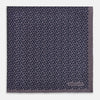 View 3 of product A folded Floral Purple Pocket Square in Silk by Turnbull & Asser UK, featuring a double-sided design with a pattern of small, dark blue circles and the brand’s logo printed in one corner.