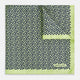 Introducing the Floral Green Pocket Square in Silk by Turnbull & Asser UK—a sophisticated accessory in light green silk, adorned with a delicate floral pattern and a folded corner. The pocket square features a refined double-sided design, with the Turnbull & Asser UK brand name elegantly printed on one corner.