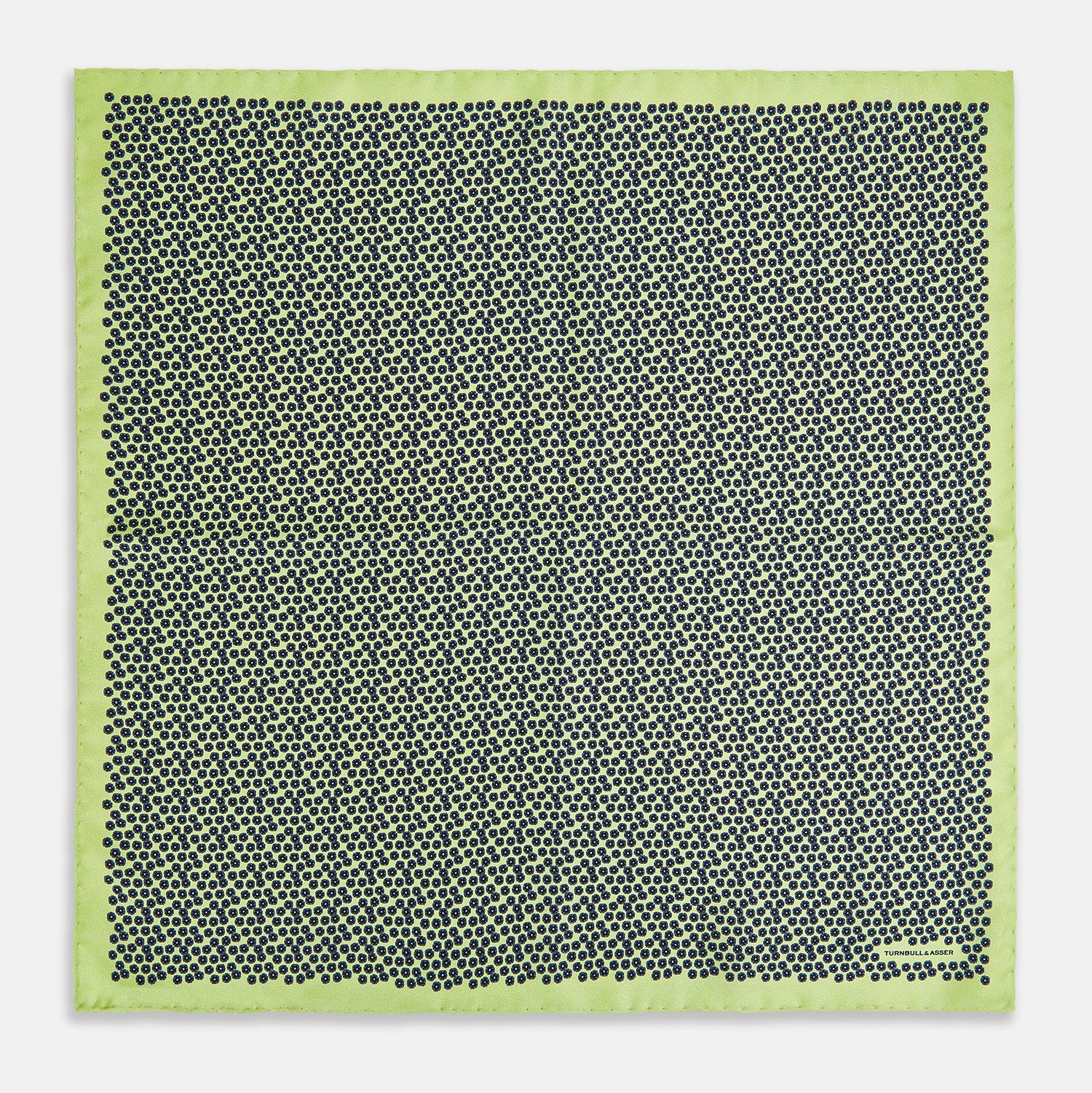 View 4 of product Introducing the Floral Green Pocket Square in Silk by Turnbull & Asser UK—a sophisticated accessory in light green silk, adorned with a delicate floral pattern and a folded corner. The pocket square features a refined double-sided design, with the Turnbull & Asser UK brand name elegantly printed on one corner.