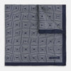 View 1 of product A Geometric Blue Pocket Square in Silk by Turnbull & Asser UK, featuring a navy blue and white geometric square tile design and a small label in the bottom right corner.