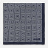 View 3 of product A Geometric Blue Pocket Square in Silk by Turnbull & Asser UK, featuring a navy blue and white geometric square tile design and a small label in the bottom right corner.