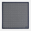 View 4 of product A Geometric Blue Pocket Square in Silk by Turnbull & Asser UK, featuring a navy blue and white geometric square tile design and a small label in the bottom right corner.