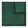 View 1 of product The Geometric Green Pocket Square in Silk by Turnbull & Asser UK features a sophisticated forest green hue with a geometric pattern of concentric squares and a visible Turnbull & Asser label in the corner.
