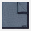View 1 of product Introducing the Polka Dot Navy Pocket Square in Silk by Turnbull & Asser UK—this elegant accessory features a refined dot motif with small white polka dots and a solid navy border. One corner is artfully folded to reveal the underside, adding visual interest, while the Turnbull & Asser branding is printed in white on one corner, making it an ideal choice for formal tailoring.