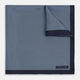 Introducing the Polka Dot Navy Pocket Square in Silk by Turnbull & Asser UK—this elegant accessory features a refined dot motif with small white polka dots and a solid navy border. One corner is artfully folded to reveal the underside, adding visual interest, while the Turnbull & Asser branding is printed in white on one corner, making it an ideal choice for formal tailoring.