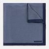 View 1 of product Crafted from silk, the Turnbull & Asser UK Polka dot Denim Pocket Square features a sophisticated navy blue hue adorned with small white polka dots and a solid border. Neatly folded with the brand label visible in one corner, this elegant accessory is ideal for enhancing formal tailoring.