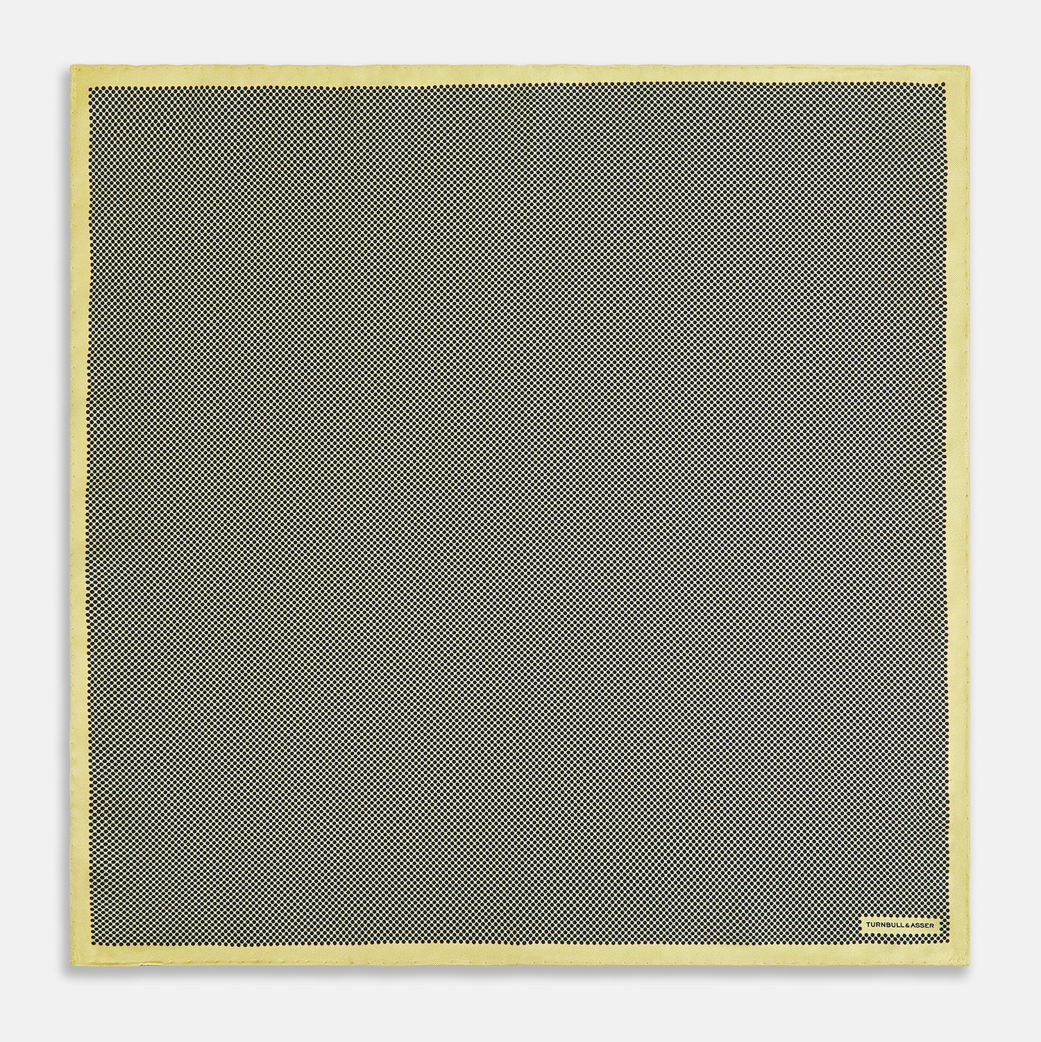 View 4 of product A folded yellow silk pocket square with a subtle polka dot pattern and yellow edges, perfect for formal tailoring. The Turnbull & Asser UK label is visible in one corner.