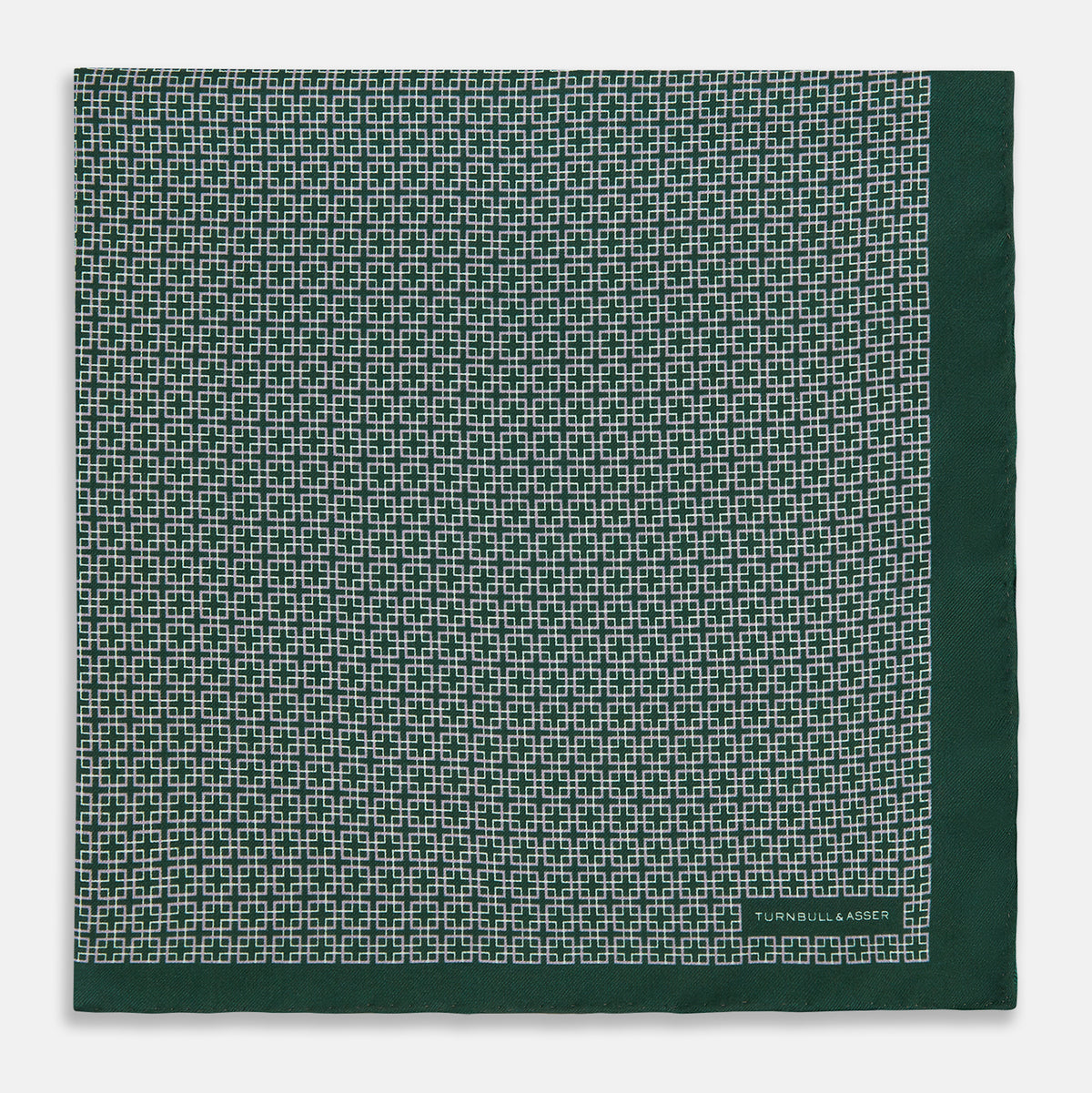 View 3 of product Turnbull & Asser UK Geometric Green Forest Green Pocket Square in Silk featuring a white geometric motif and a solid green border.